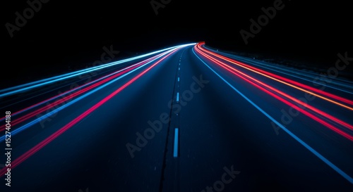 Speeding lights on a dark highway at night.