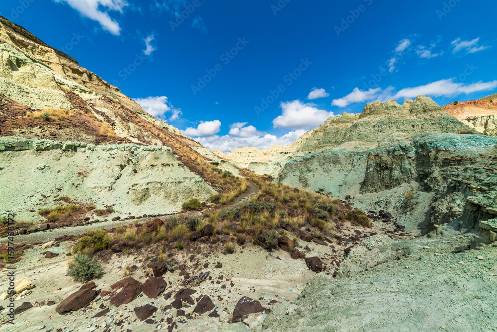 Obraz premium Rainbow Colored Mountains And Sunny Skies