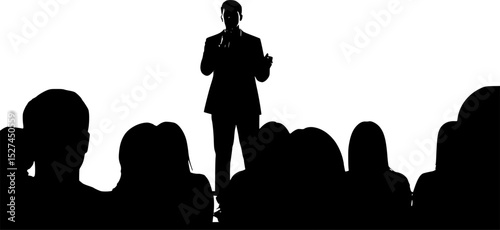 A silhouetted figure of a performer stands on a stage, microphone in hand, addressing an audience