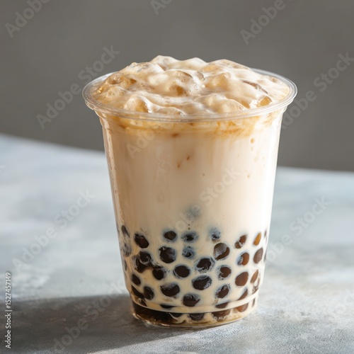 Bubble tea with tapioca pearls in a clear cup, ideal for showcasing a creamy and flavorful treat.