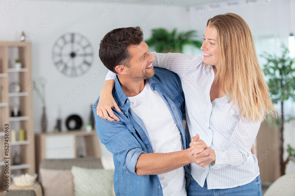 Obraz premium playful couple waltzing in the home
