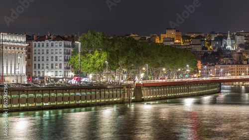 Timelapse of the Lyon Court of Appeal at night, a neo-classical courthouse at Place Duquaire in Lyon's 5th arrondissement. Scenic views of the Saone waterfront and red suspension footbridge. France.