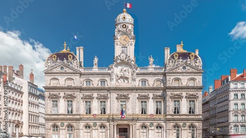 Hyperlapse of Hotel de Ville de Lyon, the historic city hall of Lyon, France. People stroll near the fountain on the square timelapse. A baroque and classical architectural marvel under a blue sky