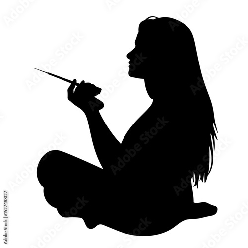 Thoughtful woman holding an object in silhouette, creative expression