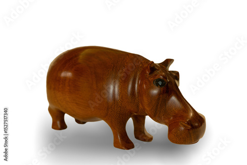 A traditional African hand-carved wooden hippo souvenir, with a shadow, isolated against a white background