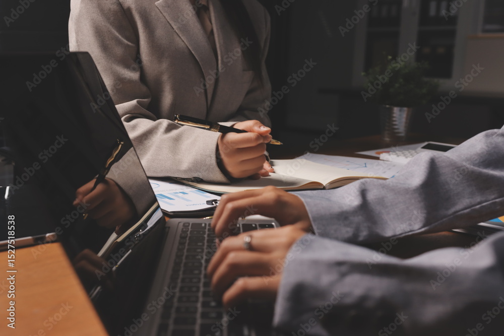Fototapeta premium Group of confident business people point to graphs and charts to analyze market data, balance sheet, account, net profit to plan new sales strategies to increase production capacity.