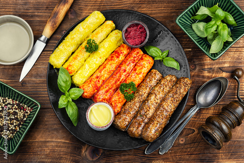 Fresh uncooked sausages on a plate.