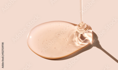 drop gel serum on beige background