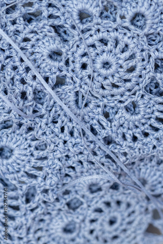 Close up of hands of unrecognizable woman knitting handmade clothes with spokes using  wool yarn. Concept of leisure activity.Knitting from yarn on  coarse spokes.