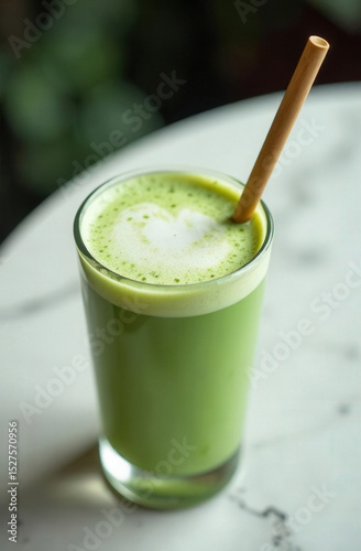 matcha latte in a glass with bamboo straw on marble surface, trendy drink aesthetic, overhead composition