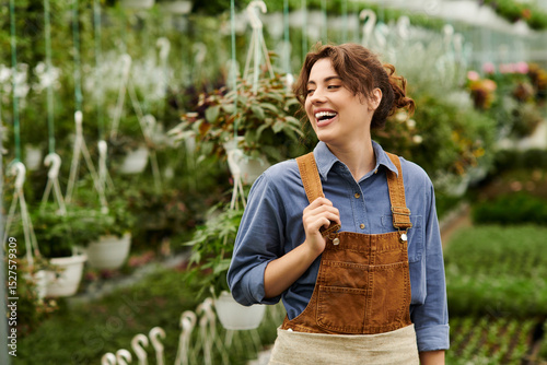 Joyful gardener tending to flourishing plants in a vibrant greenhouse space