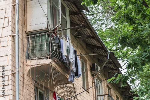 Laundry drying on an old balcony in Bishkek. Everyday life in the city.