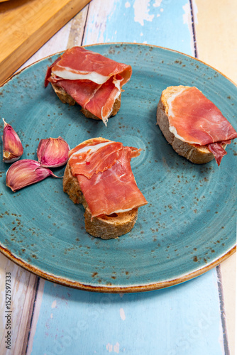 Freshly baked, crusty bread, a touch of olive oil, and slices of ham 