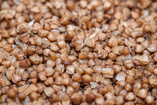 Plate with tasty buckwheat porridg.Boiled buckwheat porridge in ceramic pot on wooden background.