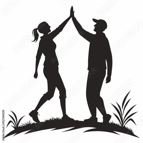 Silhouette of a couple high fiving outdoors