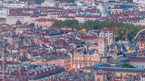 Aerial timelapse of Hotel de Ville de Lyon day to night transition, the historic city hall of Lyon, France. Historic center with red roofs from above. A baroque and classical architectural marvel
