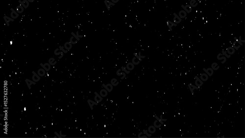 Chaotic white bokeh on a black background with small falling snowflakes. Snow storm effect,