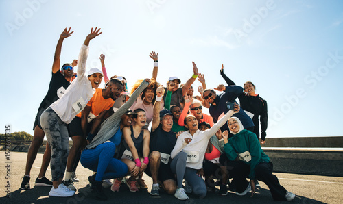 Lively neighborhood running club celebrating together outdoors