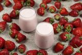 Strawberry Yogurt Served in Glasses Surrounded by Fresh Ripe Strawberries.