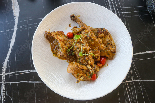 Wall Mural Traditional maltese national dish stewed rabbit on the table in restaurant