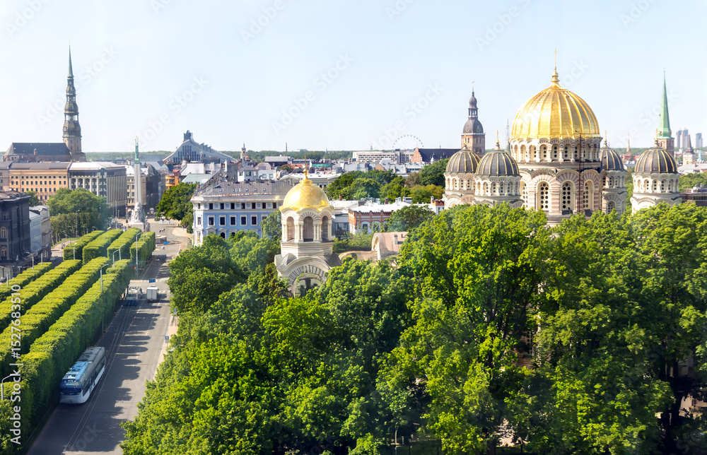 Naklejka premium Aerial view of Riga city center with the main Orthodox Cathedral with golden domes surrounded by green trees of the park in Riga. Latvia