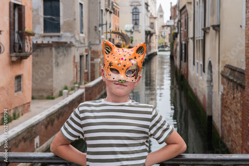Child with colorful carnival mask in Venice photo