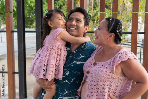 Happy hispanic family sharing a tender moment outdoors
