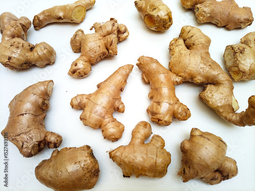 Fototapeta Naklejka Na Ścianę i Meble -  Fresh ginger roots or ginger rhizome on white background, top view
