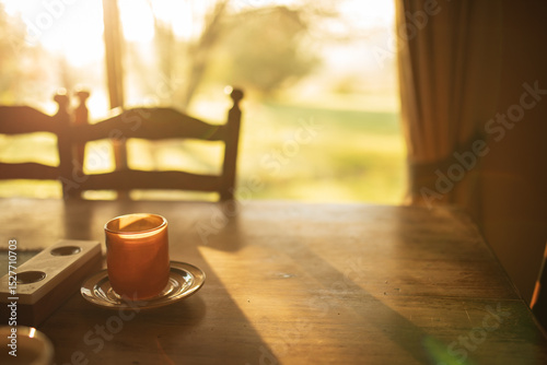 Warm morning sunlight beaming through window of country home onto kitchen table