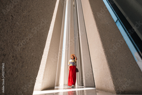 Wallpaper Mural Young Woman Exploring Contemporary Building with tall concrete columns, stone wall. light and shadow patters, Museum architecture in Abu Dhabi, the cultural capital

 Torontodigital.ca