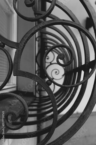 Fotografie Intricate ironwork design spirals beautifully along a balcony overlooking a quie