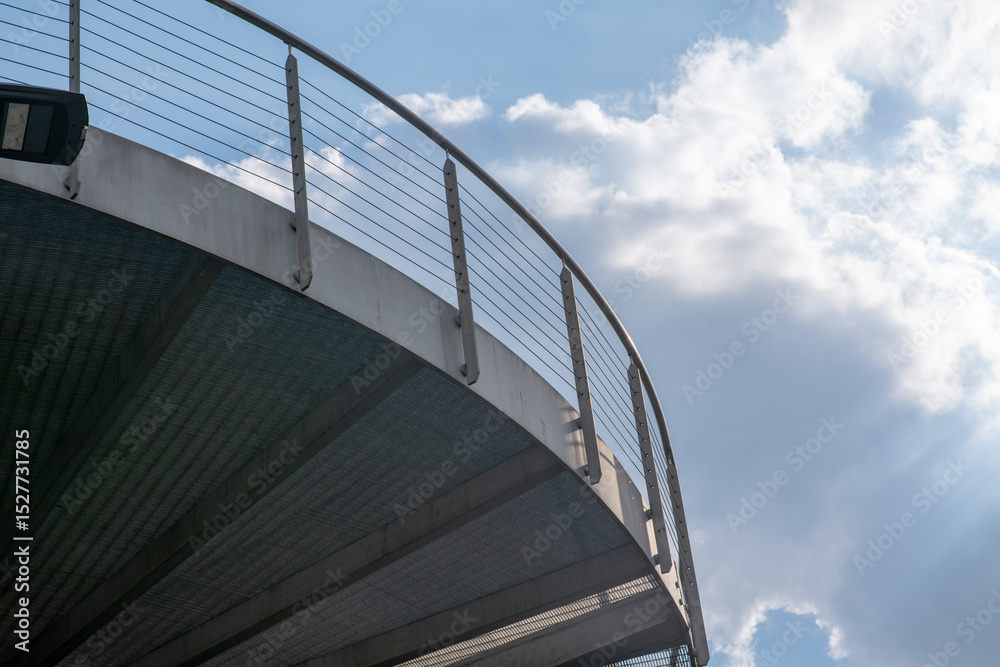 Fototapeta premium helical pedestrian ramp project in external steel, modern and innovative design staircase, for contemporary architecture. stainless steel design is designed for a pedestrian overpass in a public area.