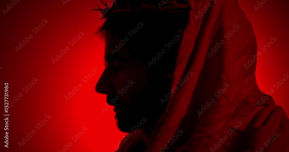 Silhouette of Jesus Christ Wearing Crown of Thorns in Red Light for Christianity, Easter visual or bible scene. Silhouette of Jesus Christ Wearing Crown of Thorns in Red Light for Christianity, Easter visual or bible scene.