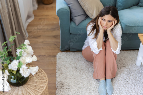 Home, woman thinking and sad, depression and mental health with stress in living room. Person, apartment and girl on floor, upset or lonely with thinking, unhappy or because of breakup with burnout.