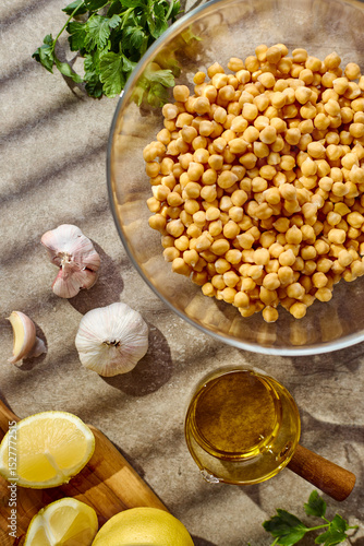 Chickpeas, lemon, tahini and herbs, ingredients for making hummus. Top view.