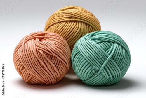 Three balls of pastel yarn isolated on white background