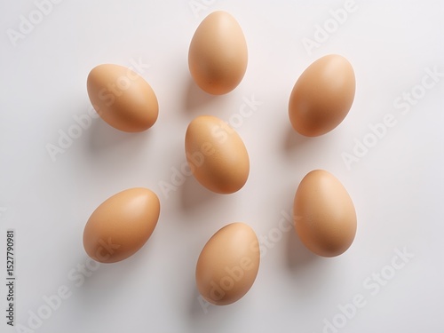Brown eggs in a simple pattern on white, embodying minimalism and natural elegance.