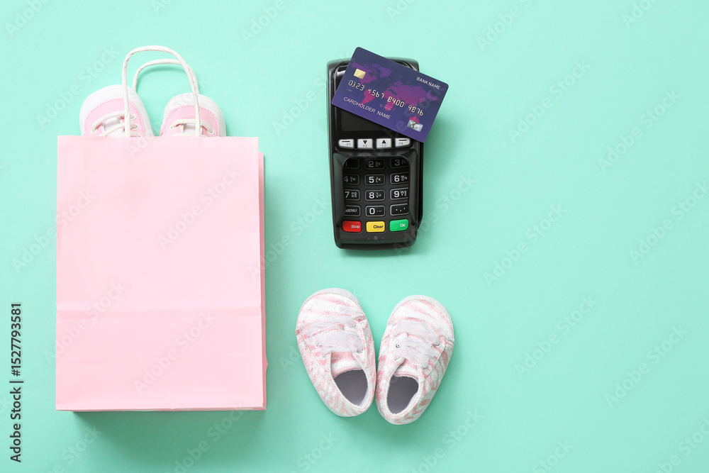 Naklejka premium Composition with shopping bag, baby shoes and payment terminal on color background