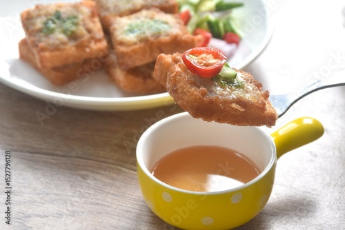 Thai crispy fried pork toast on plate eat couple with pickled vegetable sauce