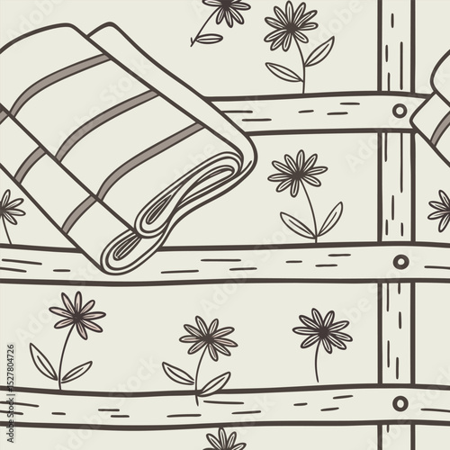 Folded striped towel resting on a wooden shelf against a floral patterned wall