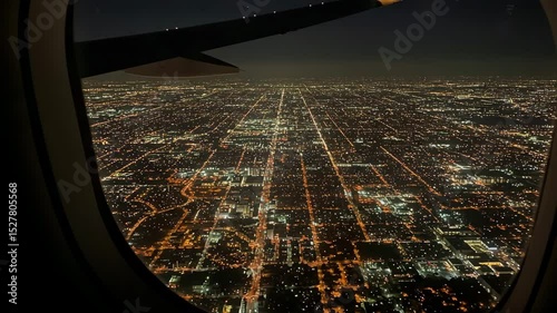 Aerial view of city lights at night from airplane window  