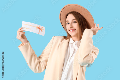 Young woman with gift card ...