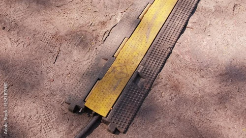 Heavy Duty PVC Duct Ground Cable Cover Protector used to Prevent Trip Hazard in Outdoor Settings