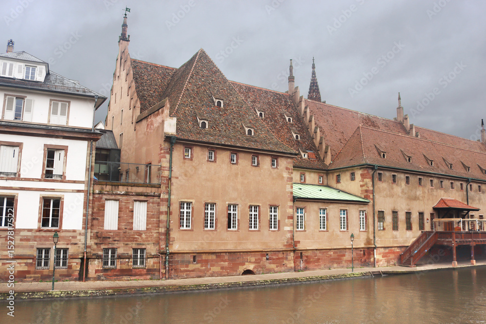 Naklejka premium Old Customs House on Ill river bank in Strasbourg city center, France