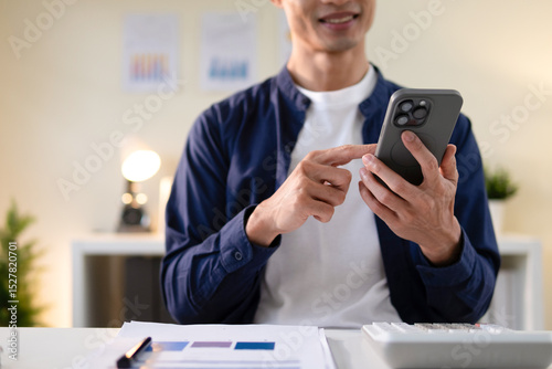 A man's hand is using a telephone to communicate.