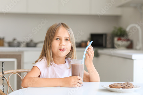 Cute little girl with glass...