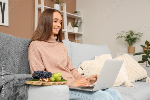 Young woman with grapes and...