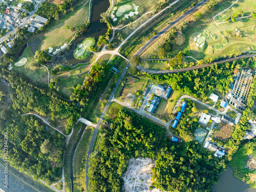 Aerial view drone shot of beautiful green golf field fairway and putting green,Top down image for sport background and travel nature background.