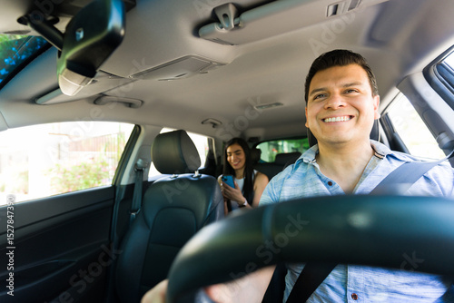 Foto Smiling rideshare driver navigating with passenger