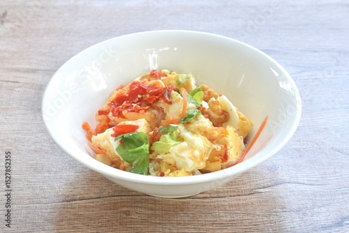spicy batter slice fried egg with tomato and shallot Thai salad on bowl